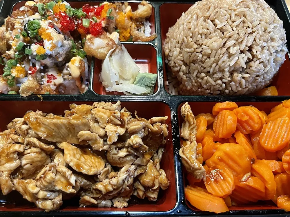 Bento Box with Teriyaki Chicken Fried Rice Carrots and Temptation Roll